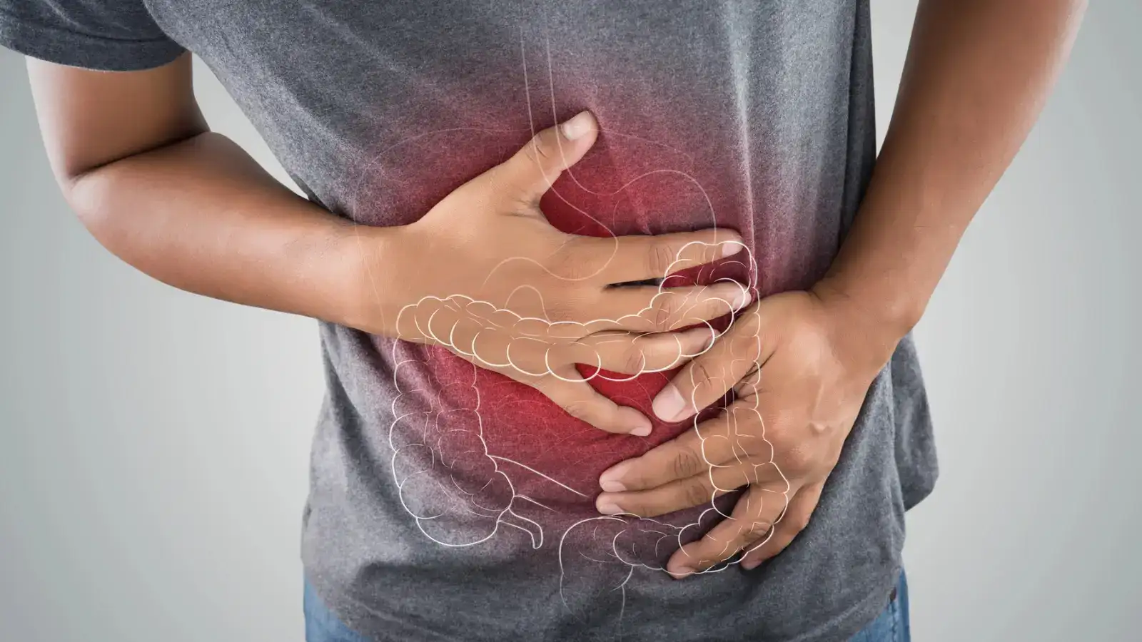 A person holding their upper abdomen with the stomach and intestines drawn over it in red